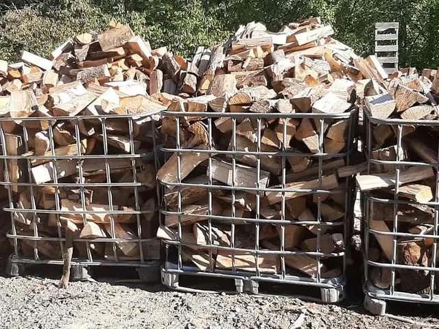 Rows of crated split hardwood seasoning in the yard