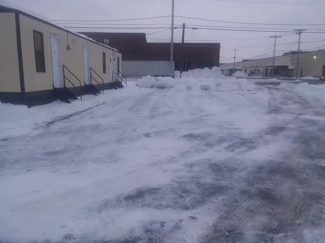 A commercial lot cleared of snow after a plow pass